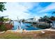 View of a canal with boats and private docks in a sunny waterfront community at 9820 Royal Palm Dr, Bradenton, FL 34210