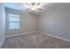 Spacious bedroom with neutral decor and carpeted floors at 9904 Wild Begonia Loop, Land O Lakes, FL 34637