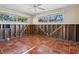 Room undergoing renovation with tiled floors and multiple windows at 1221 S Basin Ln, Sarasota, FL 34242