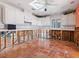 Damage kitchen with white cabinets, tile floor, and exposed framing at 1221 S Basin Ln, Sarasota, FL 34242