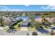 Stunning aerial view of a luxurious home with a three-car garage near a serene lake at 12343 Lavender Loop, Bradenton, FL 34212