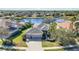 Captivating aerial shot of a lakeside residence featuring a three-car garage and mature landscaping at 12343 Lavender Loop, Bradenton, FL 34212