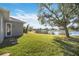 Beautiful backyard featuring lush green grass and a serene water view at 12343 Lavender Loop, Bradenton, FL 34212