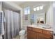 Bright bathroom with a shower, toilet, and vanity with wooden cabinets at 12343 Lavender Loop, Bradenton, FL 34212