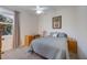 Comfortable bedroom with a ceiling fan, dresser/desk combo, and full-sized bed at 12343 Lavender Loop, Bradenton, FL 34212