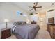 Comfortable bedroom with a neutral color scheme, ceiling fan, and stylish furniture at 12343 Lavender Loop, Bradenton, FL 34212
