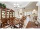 Elegant dining room with a wood table, hutch, and chandelier at 12343 Lavender Loop, Bradenton, FL 34212