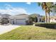 Charming home with a well-manicured lawn, a three-car garage, and attractive landscaping at 12343 Lavender Loop, Bradenton, FL 34212