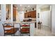 Cozy kitchen featuring wooden cabinets, neutral countertops, and barstool seating at the counter at 12343 Lavender Loop, Bradenton, FL 34212