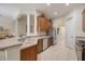 Charming kitchen with stainless steel appliances, tile flooring, and bright natural light at 12343 Lavender Loop, Bradenton, FL 34212
