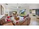 Bright living room features sliding glass doors to the backyard and comfortable leather seating at 12343 Lavender Loop, Bradenton, FL 34212