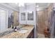 Bathroom with granite vanity and a walk-in shower at 17118 Vardon Ter # 305, Bradenton, FL 34211