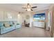 Living room with light teal couches, white cabinet, and large TV at 1898 Wharf Rd, Sarasota, FL 34231