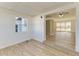 View of a living room with wood-look flooring, white walls, and an adjacent room through an open doorway at 22220 Lasalle Rd, Port Charlotte, FL 33952