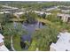 Aerial view of condo community with lake and lush trees at 305 30Th W Ave # A208, Bradenton, FL 34205