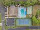 Aerial view of community features including pool, tennis court, shuffleboard, and clubhouse at 305 30Th W Ave # A208, Bradenton, FL 34205