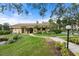 Landscaped clubhouse exterior with pond feature at 305 30Th W Ave # A208, Bradenton, FL 34205