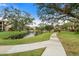 Curving path alongside a pond with lush landscaping at 305 30Th W Ave # A208, Bradenton, FL 34205