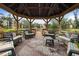 Relaxing gazebo with seating overlooking a pond at 305 30Th W Ave # A208, Bradenton, FL 34205