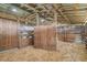 Interior of a rustic wood barn stall with wood shavings at 3120 Lena Ln, Sarasota, FL 34240