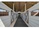 White and gray barn stalls with wood flooring and a metal roof at 3120 Lena Ln, Sarasota, FL 34240