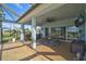 Outdoor kitchen and dining area under covered patio with ceiling fan at 3120 Lena Ln, Sarasota, FL 34240