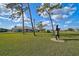 Landscaped front yard with a horse statue, tall trees and a home visible at 3120 Lena Ln, Sarasota, FL 34240