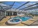 Relaxing pool and spa area with a screened enclosure and stone patio at 3120 Lena Ln, Sarasota, FL 34240