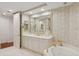 Elegant bathroom boasting a soaking tub and marble finishes at 35 Watergate Dr # 801, Sarasota, FL 34236