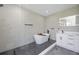 Spa-like bathroom with a soaking tub, walk-in shower, and modern vanity at 3791 Surrey Ln, Sarasota, FL 34235