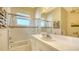 This bathroom features a tub and shower combination, with lots of wall storage at 3930 Elysian Woods Ln, Sarasota, FL 34231