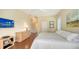 Spacious bedroom with wood flooring, dresser, and a mounted TV at 3930 Elysian Woods Ln, Sarasota, FL 34231