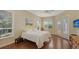 Inviting bedroom with natural light, wood floors, and access to the balcony at 3930 Elysian Woods Ln, Sarasota, FL 34231