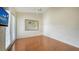 This bedroom features hardwood floors, a TV and a walk out to the patio at 3930 Elysian Woods Ln, Sarasota, FL 34231