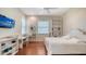 This bedroom features hardwood floors, lots of natural light and a mounted television at 3930 Elysian Woods Ln, Sarasota, FL 34231
