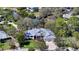 Aerial view of a home with a metal roof, manicured lawn, and lovely landscaping at 3930 Elysian Woods Ln, Sarasota, FL 34231