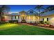 Charming home featuring a well-manicured lawn, brick path, and cozy front porch at 3930 Elysian Woods Ln, Sarasota, FL 34231