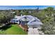 Aerial view of a beautiful home boasting a metal roof, manicured lawn, and mature landscaping at 3930 Elysian Woods Ln, Sarasota, FL 34231