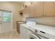 This laundry room features a washer and dryer, utility sink and lots of storage at 3930 Elysian Woods Ln, Sarasota, FL 34231