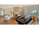 Sunlit living room with stone fireplace, hardwood floors and piano at 3930 Elysian Woods Ln, Sarasota, FL 34231