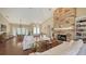 Bright living room featuring a stone fireplace, hardwood floors, and abundant natural light at 3930 Elysian Woods Ln, Sarasota, FL 34231
