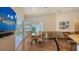 Open-concept living and dining area with large windows and access to the balcony at 3930 Elysian Woods Ln, Sarasota, FL 34231