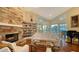 Bright living room with a stone fireplace, a built-in bookcase, and an outdoor view at 3930 Elysian Woods Ln, Sarasota, FL 34231