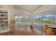 Bright living room with hardwood floors and view to the patio and pool at 3930 Elysian Woods Ln, Sarasota, FL 34231