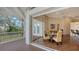 Expansive outdoor living space, with a screened patio, wooden deck, dining table, and views of the lush backyard at 3930 Elysian Woods Ln, Sarasota, FL 34231