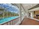 Spacious screened lanai with a clear view of the pool, deck, and backyard connecting to an indoor piano room at 3930 Elysian Woods Ln, Sarasota, FL 34231