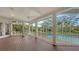 Large wooden patio with a screened pool and views of the spacious backyard, with ample sunlight at 3930 Elysian Woods Ln, Sarasota, FL 34231