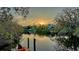 Picturesque water view from dock at sunset, surrounded by lush greenery at 3930 Elysian Woods Ln, Sarasota, FL 34231