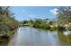 Picturesque waterfront view showcasing surrounding houses, docks and lush greenery at 3930 Elysian Woods Ln, Sarasota, FL 34231