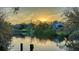 Beautiful waterfront view at sunset showing reflections and lush trees at 3930 Elysian Woods Ln, Sarasota, FL 34231